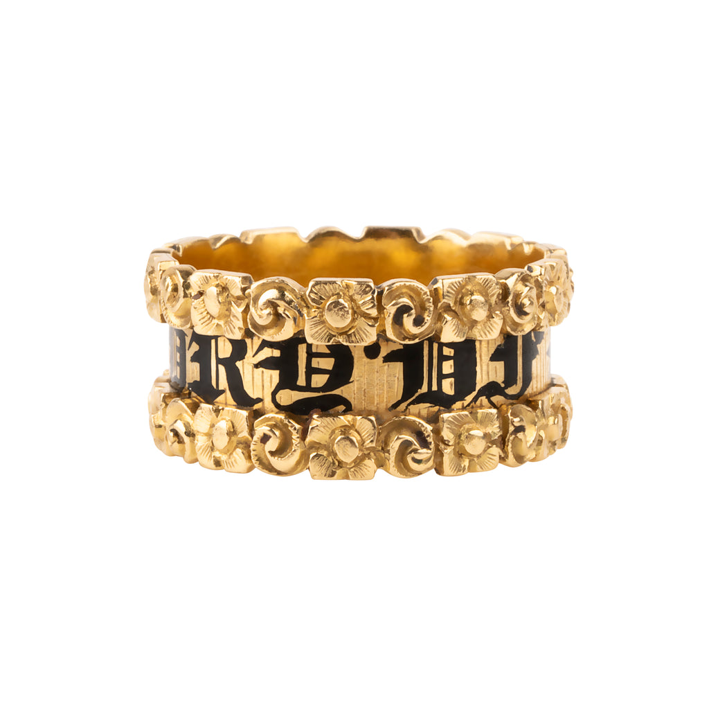 Early Victorian era wide mourning band, in 18k gold. Reads "In Memory Of" in black enamel with chased floral details. English in origin. London hallmarks. Circa 1814.