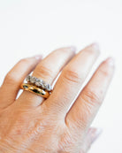 Victorian-era five-stone diamond ring, in a silver-topped gold setting. Five bright old mine-cut diamonds set in cutaway settings. England, circa 1860. Ring being modeled on the hand. 