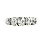 Victorian-era five-stone diamond ring, in a silver-topped gold setting. Five bright old mine-cut diamonds set in cutaway settings. England, circa 1860. Front view. 