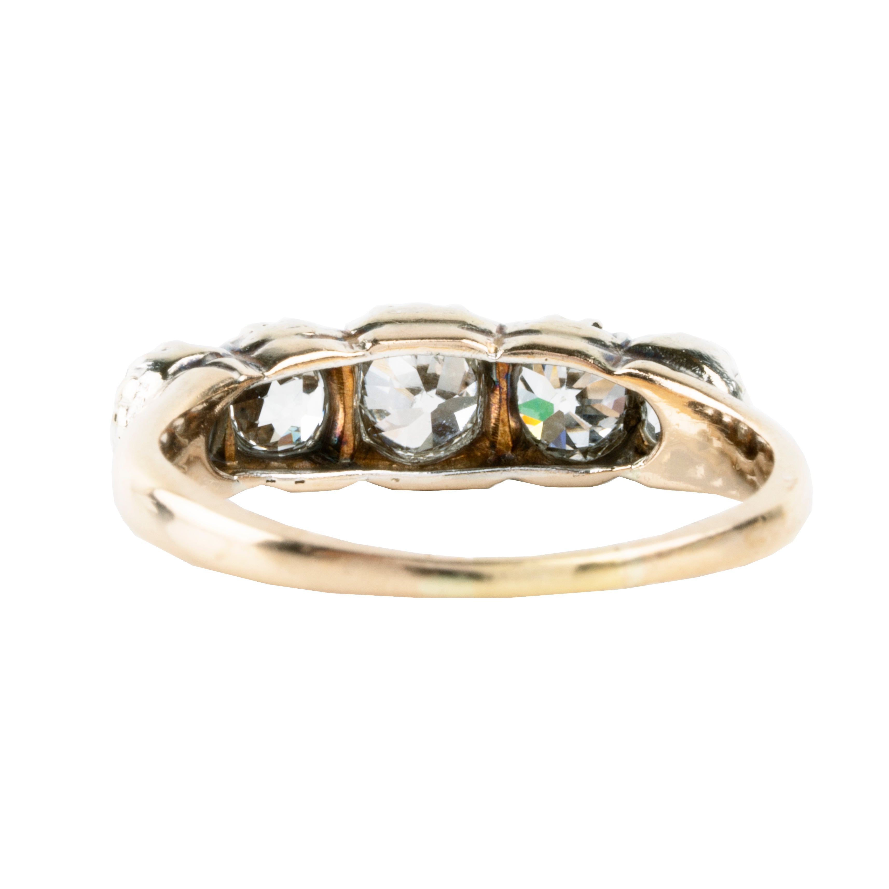Victorian-era five-stone diamond ring, in a silver-topped gold setting. Five bright old mine-cut diamonds set in cutaway settings. England, circa 1860. Backside view.
