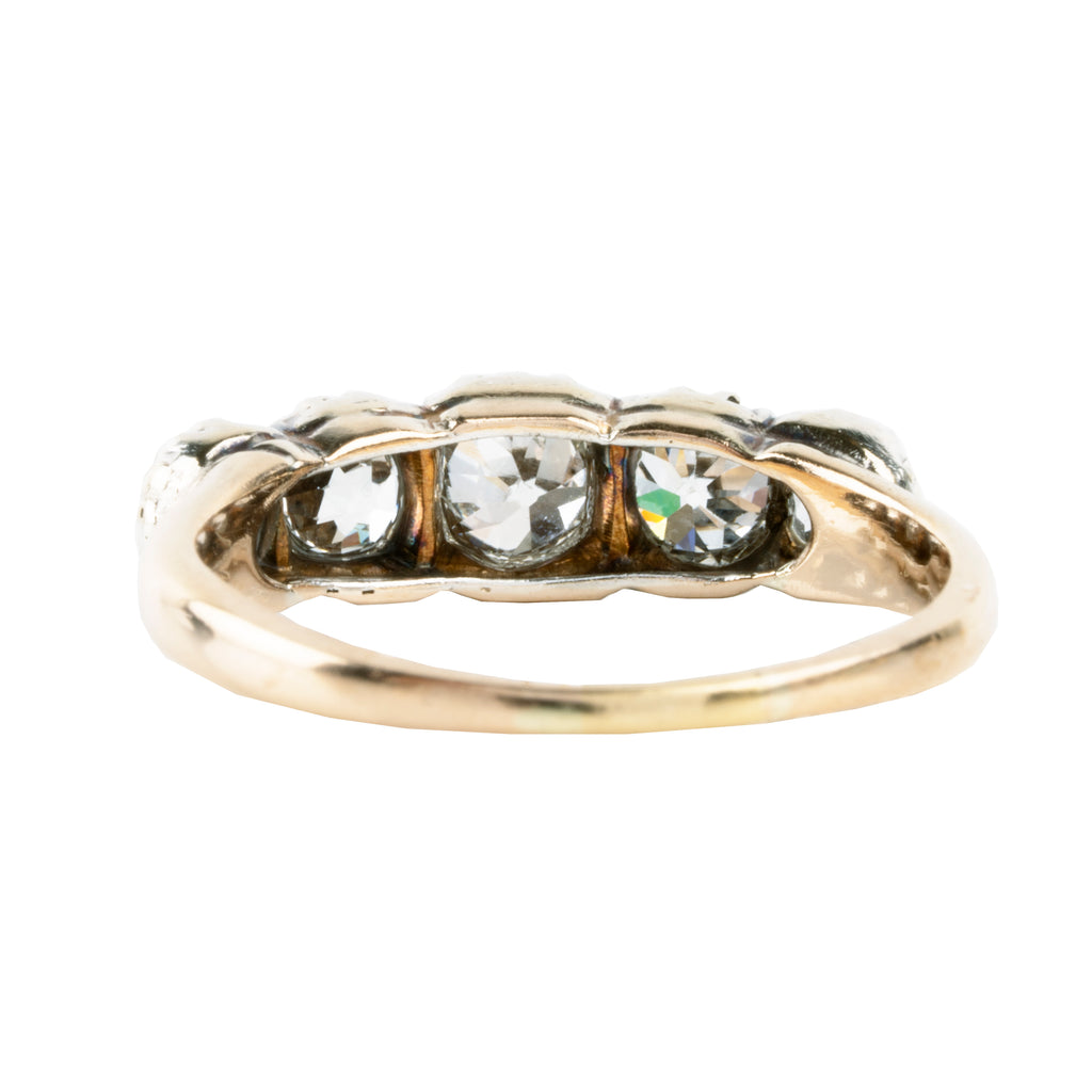 Victorian-era five-stone diamond ring, in a silver-topped gold setting. Five bright old mine-cut diamonds set in cutaway settings. England, circa 1860. Backside view.