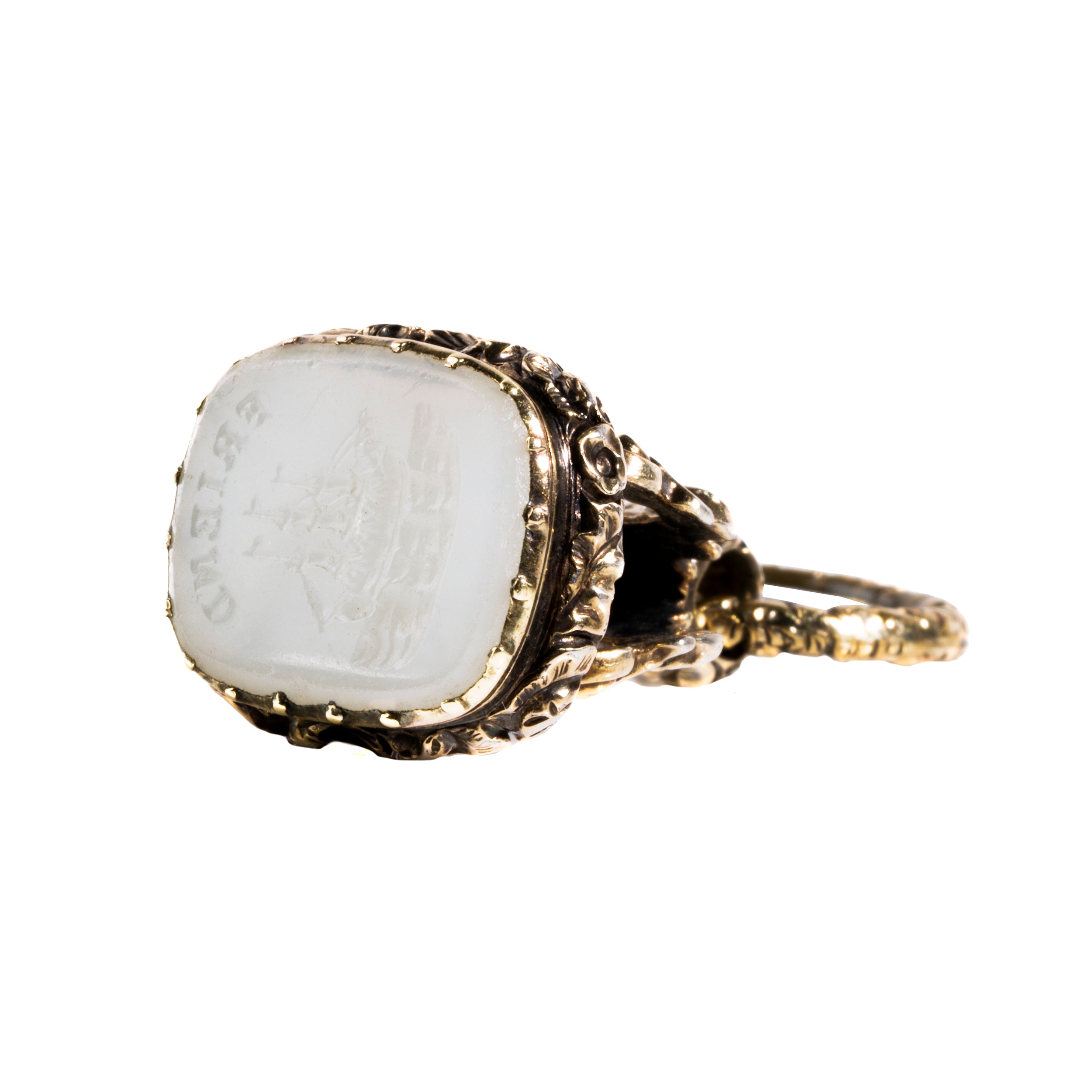 Victorian era watch fob in 9k gold. Carved white agate seal with a rebus puzzle depicting the word “friend” and a ship. English in origin. Circa 1880. Side view of the engraving of the fob. 