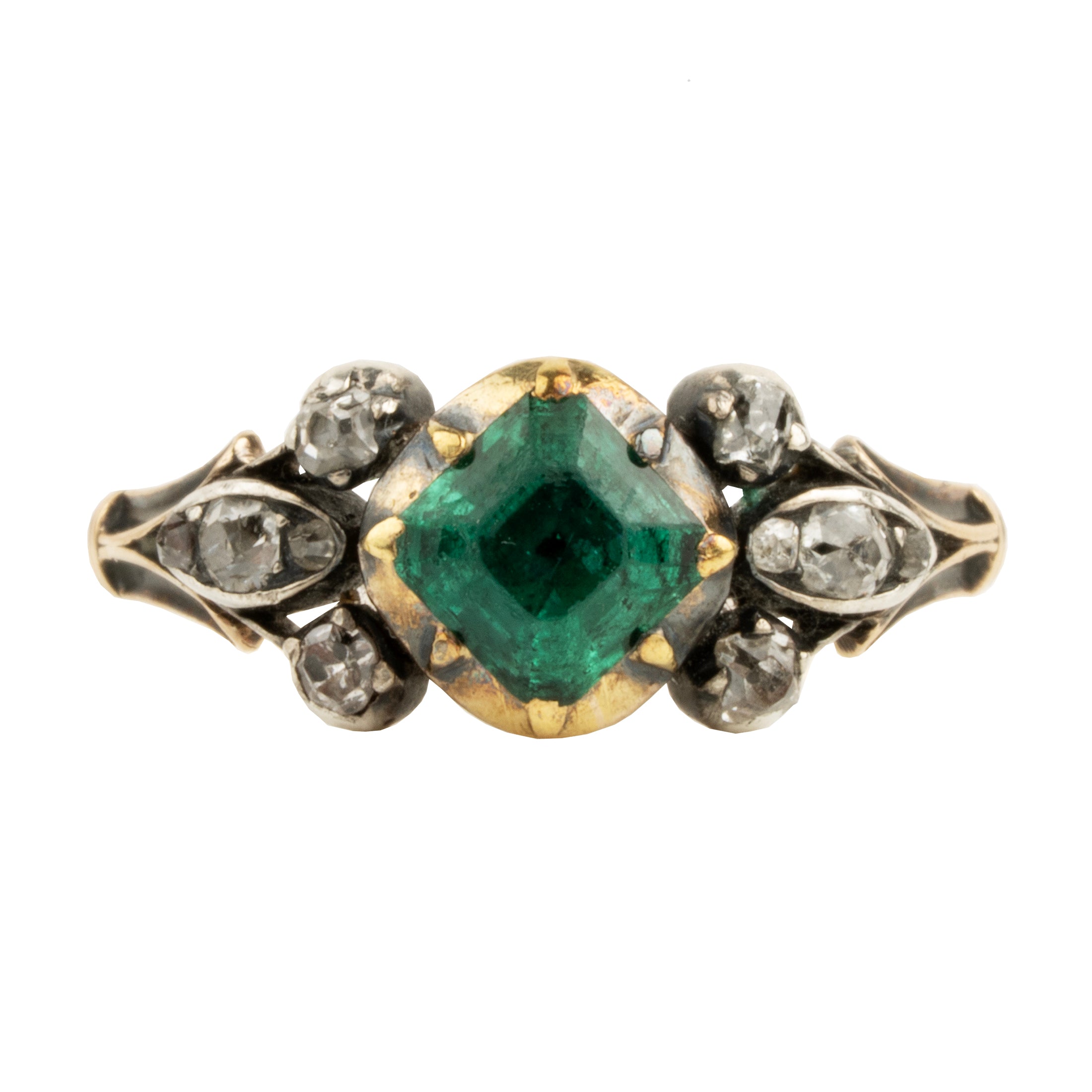 An antique-style ring featuring a central green emerald-cut gemstone flanked by small clear stones in a gold-toned setting, with a silver-toned band decorated with four small round diamonds.