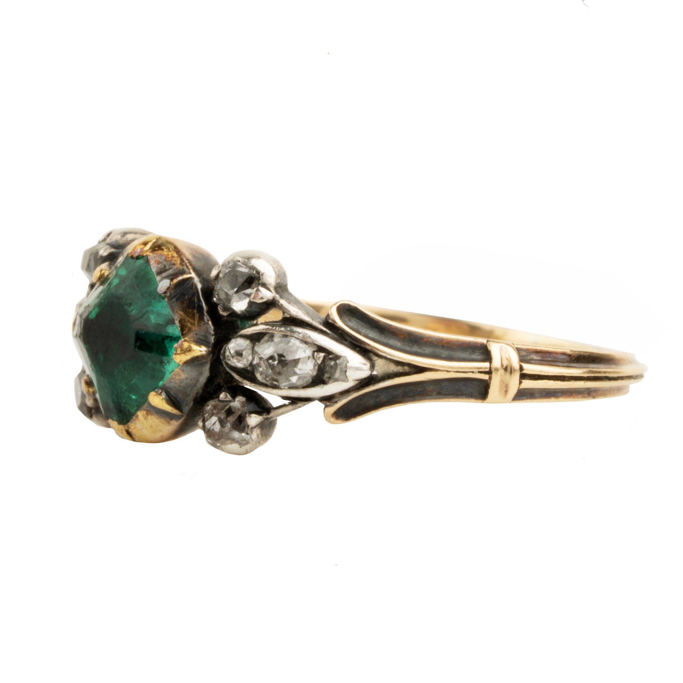 An antique-style ring featuring a prominent green emerald-cut gemstone, surrounded by small clear stones and set in a yellow gold and silver-toned metal band with dark enamel detailing.