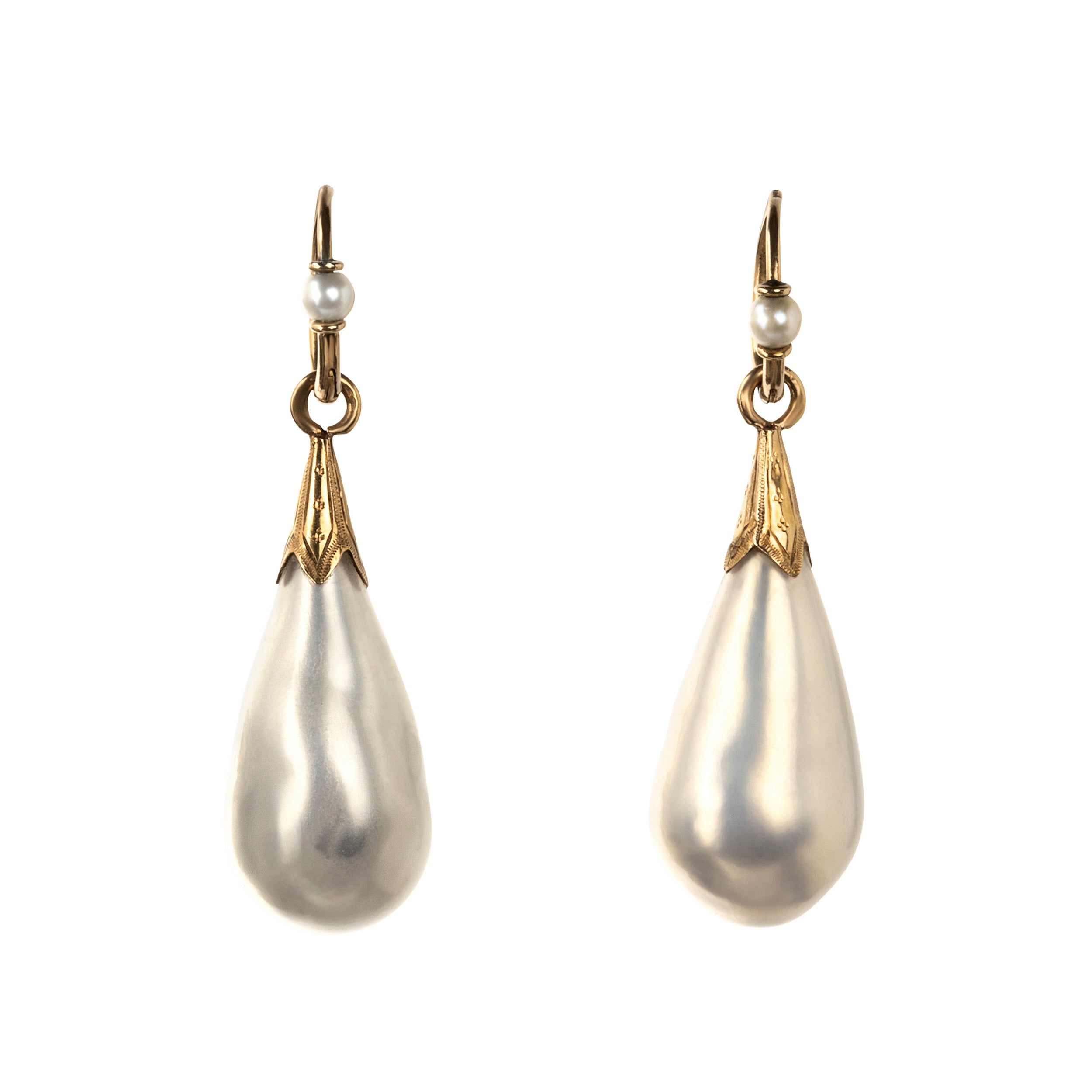 In the 18th century, glass pearl earrings were a popular alternative to natural pearls, and they commanded great prices. These imitation pearls were made by coating the interior of blown glass with a pearlescent ‘nacre’ derived from fish scales and gelatin. Earrings of the time reflected the Baroque and Rococo fashion, favoring long, dangling styles like girandole and pendant earrings.&nbsp; They were a staple in 18th-century jewelry, but their delicate nature makes them very rare today. England. Circa 1870