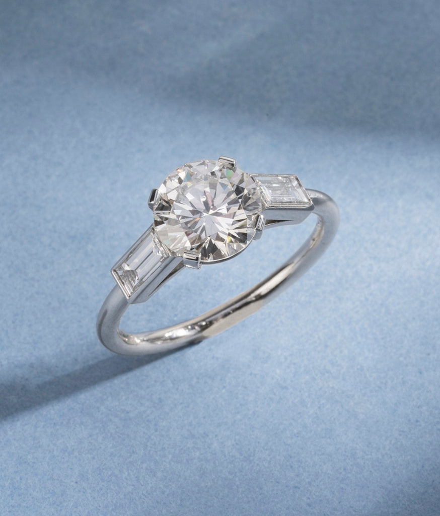 BELL & BIRD ROUND BRILLIANT CUT DIAMOND AND BAGUETTE RING