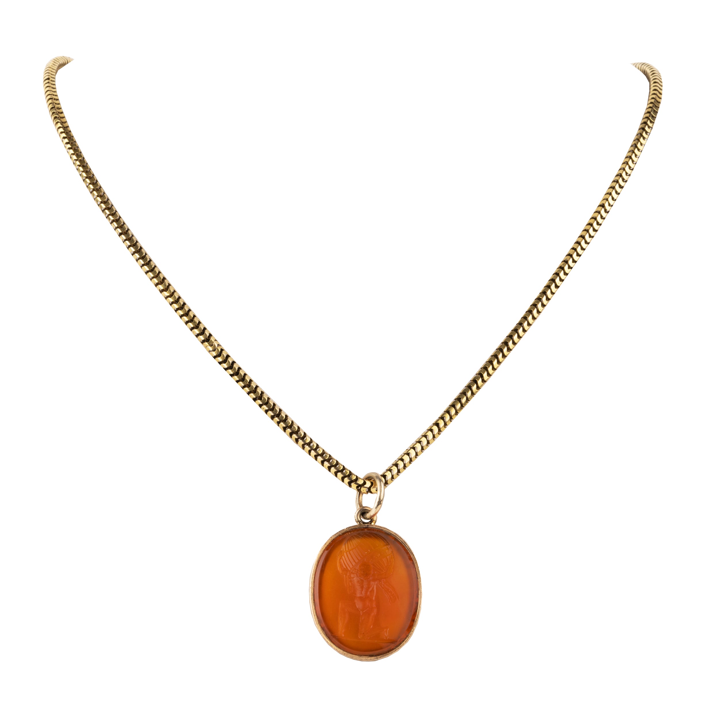 Victorian era carnelian intaglio pendant, in 15k gold. The carving depicts Atlas holding the sky, representing endurance, strength, or commitment. English in Origin. Circa 1830. Then pendant hanging from a chain. 