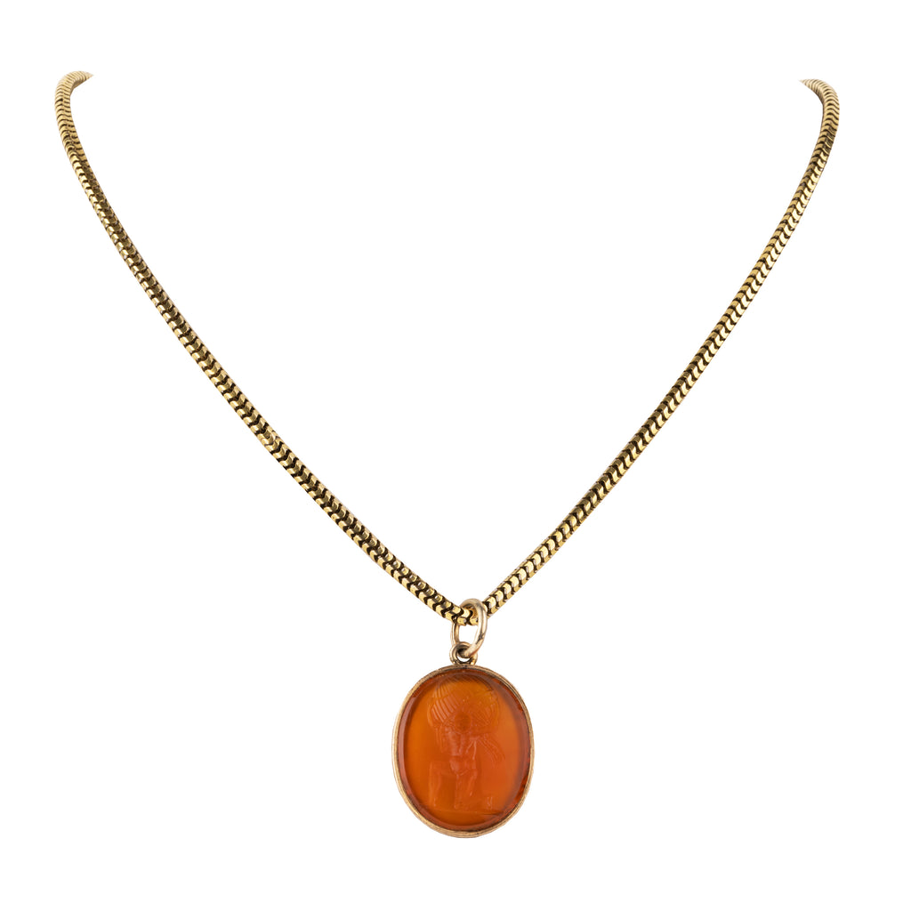 Victorian era carnelian intaglio pendant, in 15k gold. The carving depicts Atlas holding the sky, representing endurance, strength, or commitment. English in Origin. Circa 1830. Then pendant hanging from a chain. 