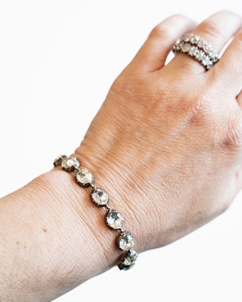 In the same form as the highly desired paste rivière necklaces, this bracelet was likely once part of a larger parure. The stones are not leaded glass paste but rock crystal quartz. Each is slightly different in size and proportion. Set in silver-topped gold collet settings. England, circa 1820. The bracelet being model. 