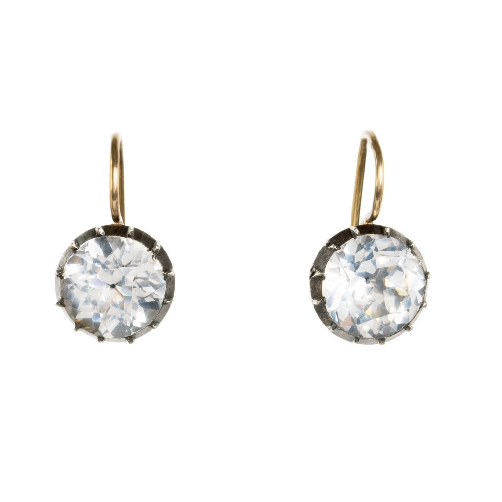 Georgian era white paste earrings, in silver and gold. Round shaped paste stones are set in foiled back silver settings on 18k gold wires. What were once beautiful Georgian era buttons or cufflinks are now perfect everyday earrings.English in origin. Circa 1820. Front view. 