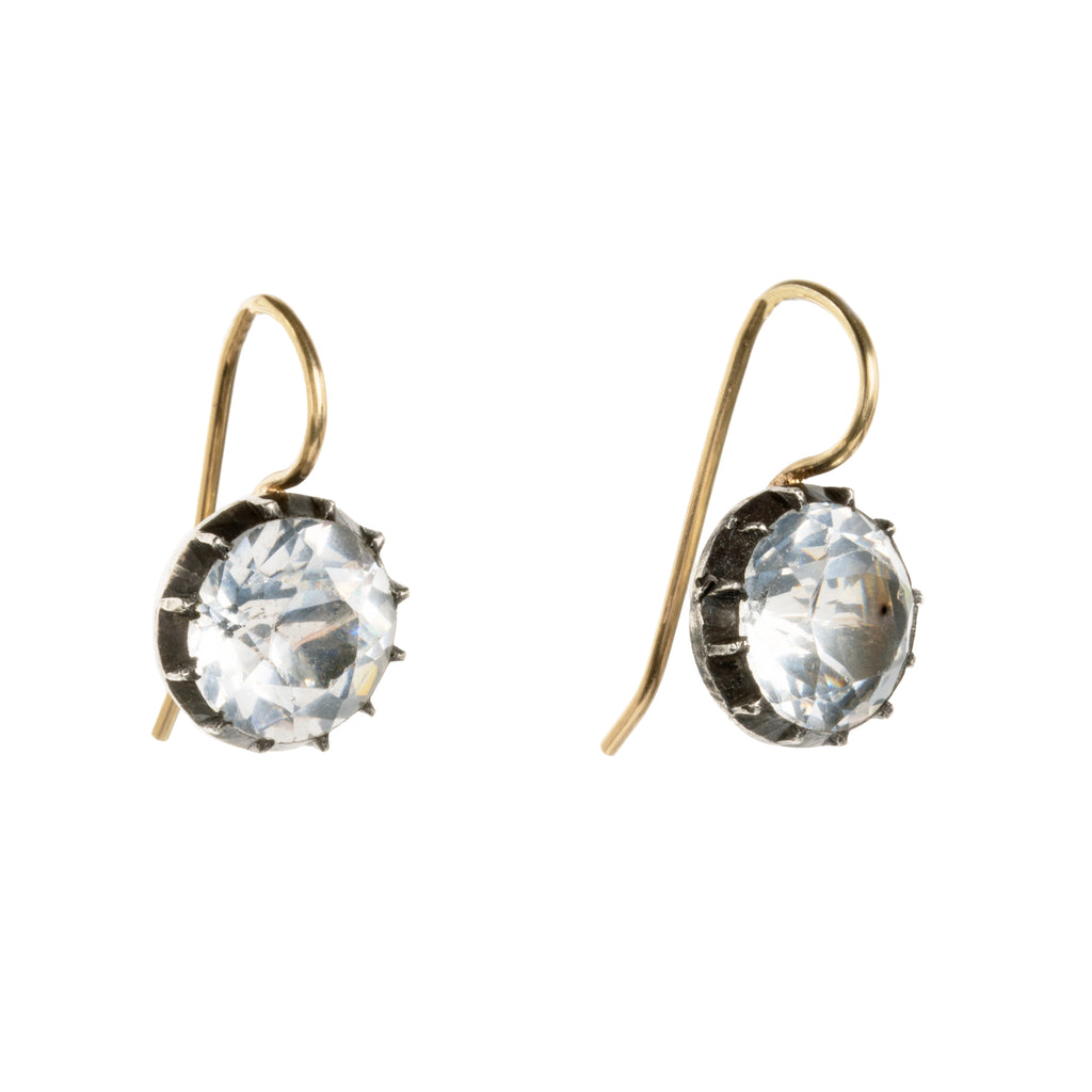 Georgian era white paste earrings, in silver and gold. Round shaped paste stones are set in foiled back silver settings on 18k gold wires. What were once beautiful Georgian era buttons or cufflinks are now perfect everyday earrings.English in origin. Circa 1820. Side view. 