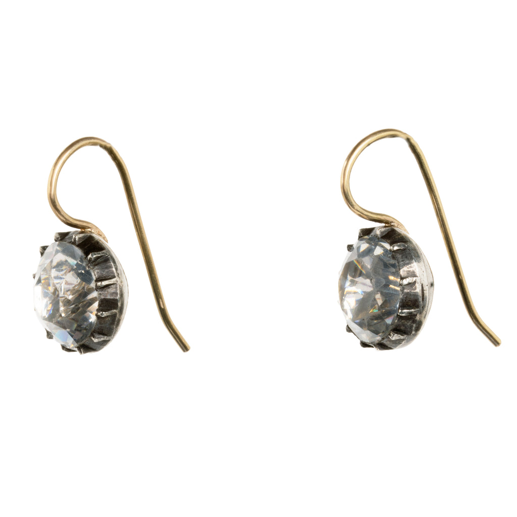 Georgian era white paste earrings, in silver and gold. Round shaped paste stones are set in foiled back silver settings on 18k gold wires. What were once beautiful Georgian era buttons or cufflinks are now perfect everyday earrings.English in origin. Circa 1820. Side view. 