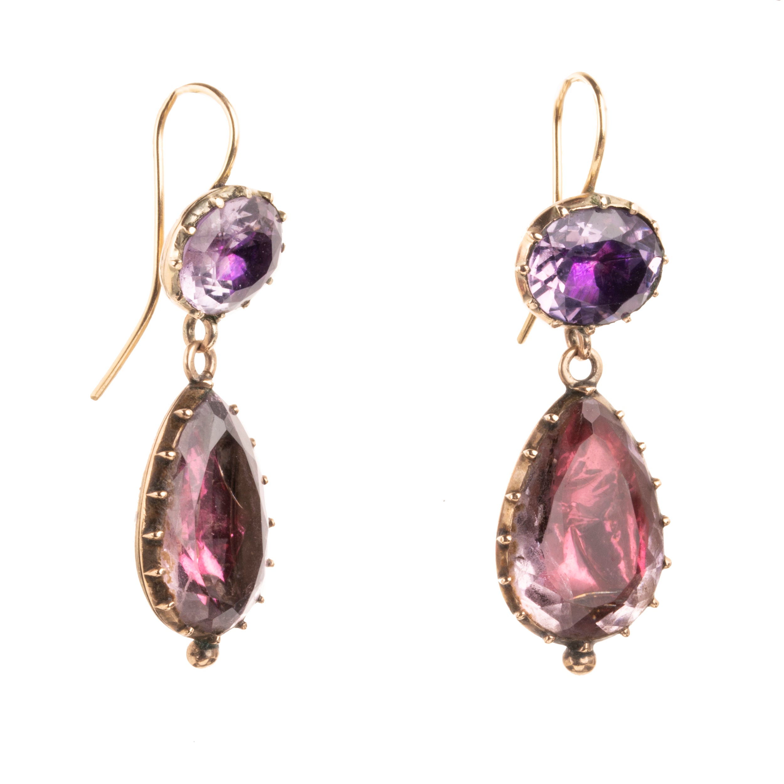 Lovely early 19th century earrings set in 15k gold. Cushion and pear shaped amethyst stones set in closed-back collet settings. The stones are a pale purple, with varied shades of purple and pink coming from the foil behind the stones. The coloring is very unique. English in origin. Circa 1800. Side view. 
