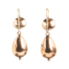 Lovely early 19th century earrings set in 15k gold. Cushion and pear shaped amethyst stones set in closed-back collet settings. The stones are a pale purple, with varied shades of purple and pink coming from the foil behind the stones. The coloring is very unique. English in origin. Circa 1800. Back side of earrings. 