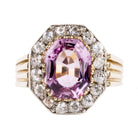 Striking ring with a large, vibrant pink precious topaz stone. It has very crisp clarity and rich color.&nbsp; The photographs do not capture the depth of color. There are sixteen mixed-cut antique diamonds surrounding the primary stone. Old Mine and old European cuts are set in platinum, while the rest of the ring is in 18k gold. England, circa 1900. Front view. 