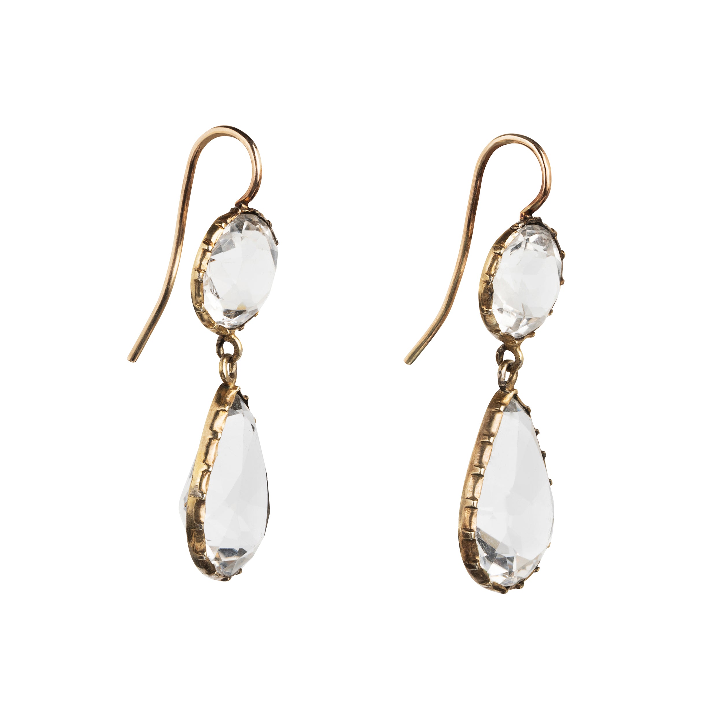 Victorian era rock crystal tear drop earrings. The stones are set in open back cut-down silver gilt settings. England. Circa 1880.