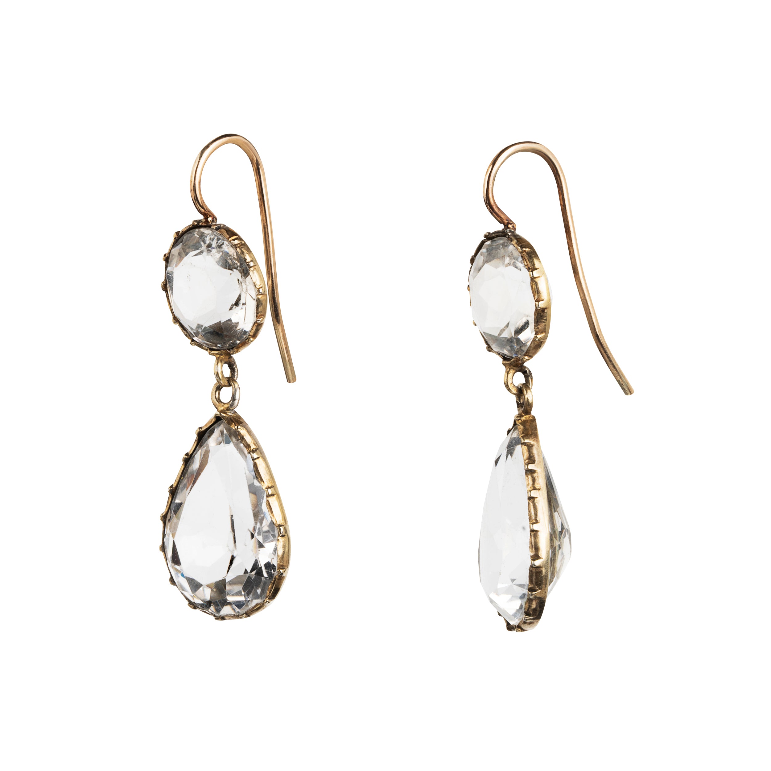 Victorian era rock crystal tear drop earrings. The stones are set in open back cut-down silver gilt settings. England. Circa 1880.