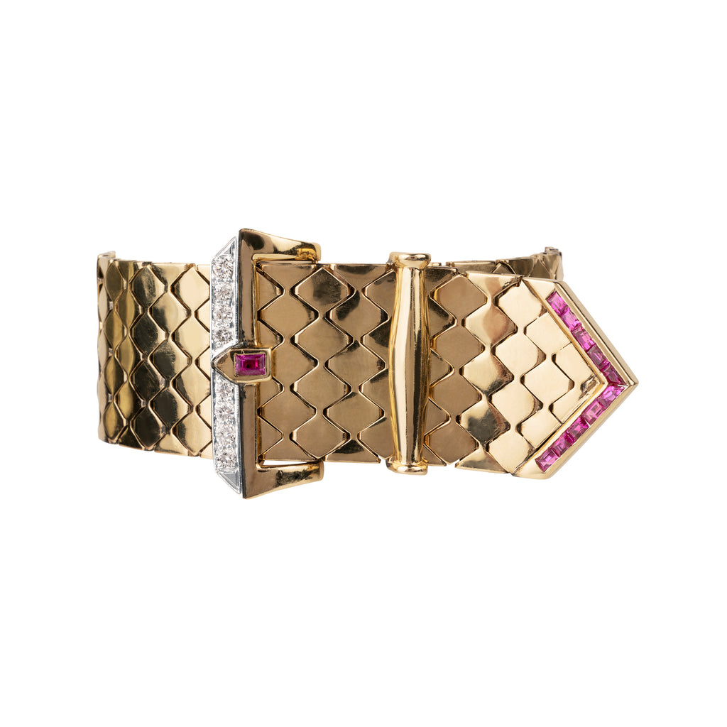 Mid-century gold buckle bracelet with rubies and diamonds in 18k gold. The functional buckle design has an adjustable fit. American in origin. Circa 1940. Front view. 