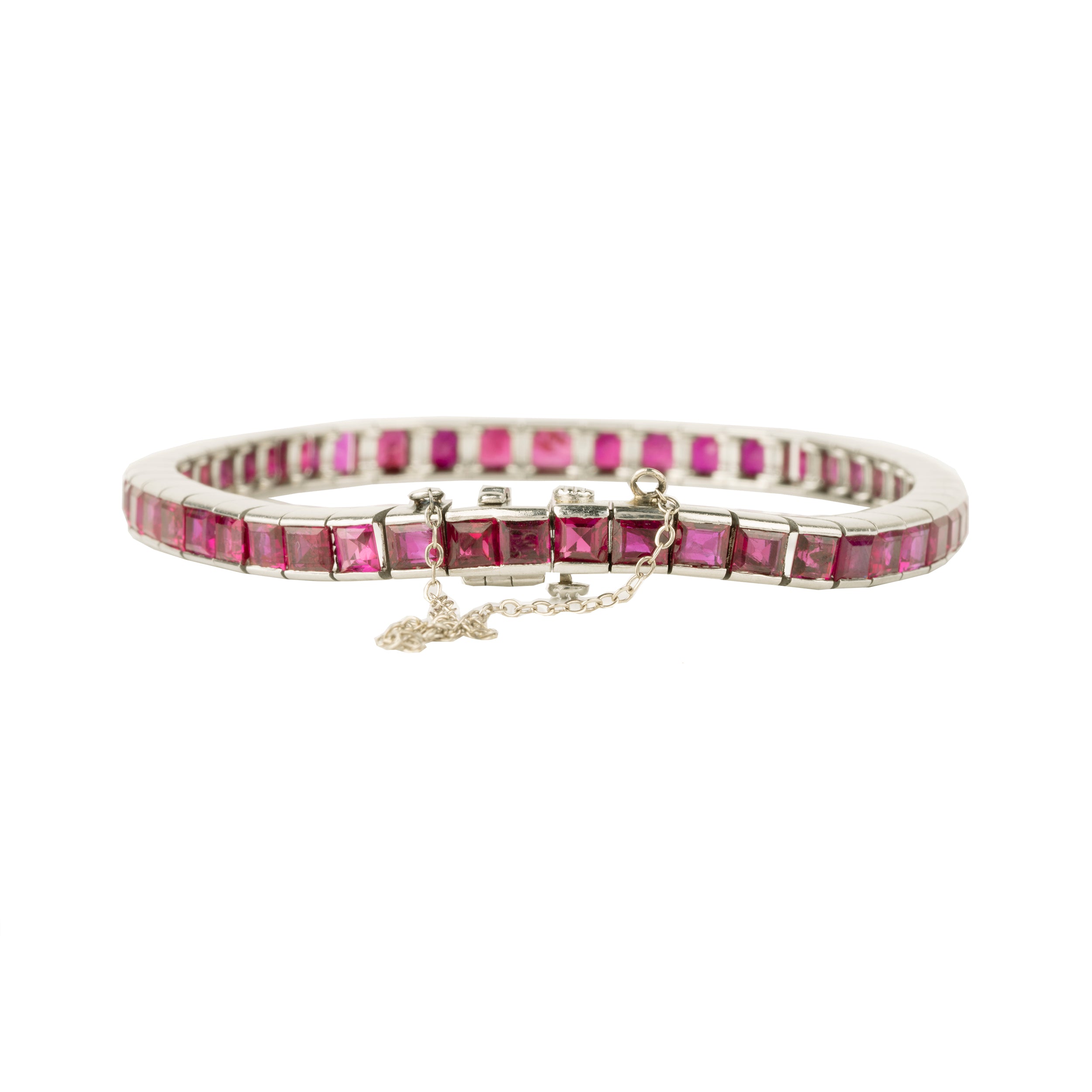 Art Deco ruby line bracelet. A fine early 20th-century platinum line bracelet. Natural deep red step-cut rubies are primarily Burmese in origin. Approximated at 11 carats in total stone weight. America, circa 1920. Side view.