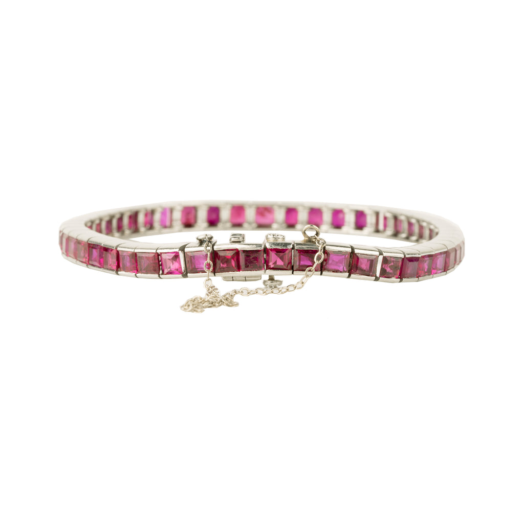 Art Deco ruby line bracelet. A fine early 20th-century platinum line bracelet. Natural deep red step-cut rubies are primarily Burmese in origin. Approximated at 11 carats in total stone weight. America, circa 1920. Side view.