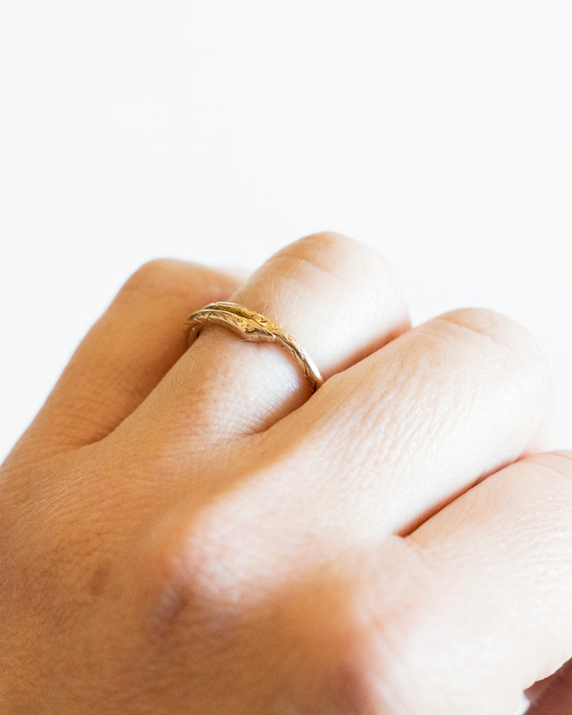 Victorian era snake split ring, in 15k gold. The ends have been soldered closed. England. Circa 1870. The ring being worn to show the scale. 