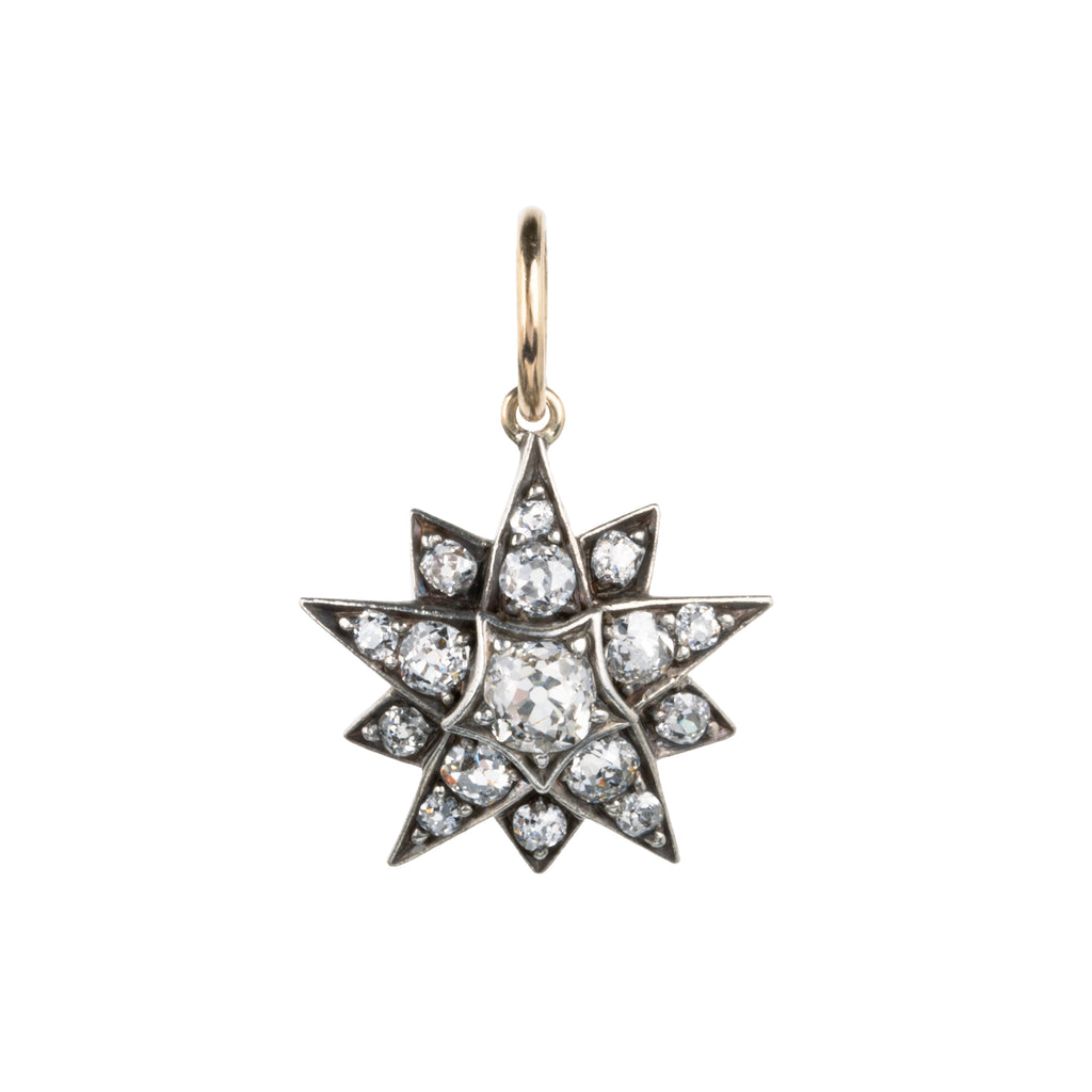 A lovely example of a 19th-century star pendant in silver-topped gold. It is a smaller scale than typically seen and very wearable. Sixteen bright old mine cut diamonds, with an estimated total diamond weight of two carats, English in origin. Circa 1880. Front view. 