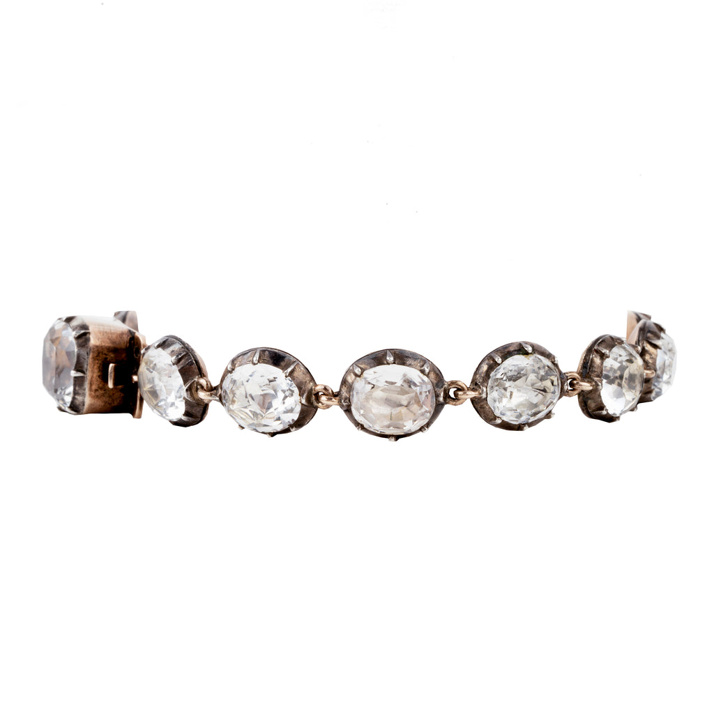 In the same form as the highly desired paste rivière necklaces, this bracelet was likely once part of a larger parure. The stones are not leaded glass paste but rock crystal quartz. Each is slightly different in size and proportion. Set in silver-topped gold collet settings. England, circa 1820. Side view. 
