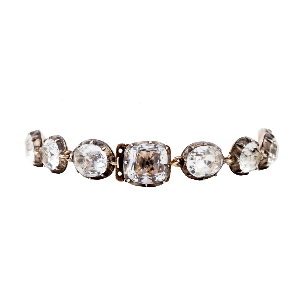 In the same form as the highly desired paste rivière necklaces, this bracelet was likely once part of a larger parure. The stones are not leaded glass paste but rock crystal quartz. Each is slightly different in size and proportion. Set in silver-topped gold collet settings. England, circa 1820. back view. 