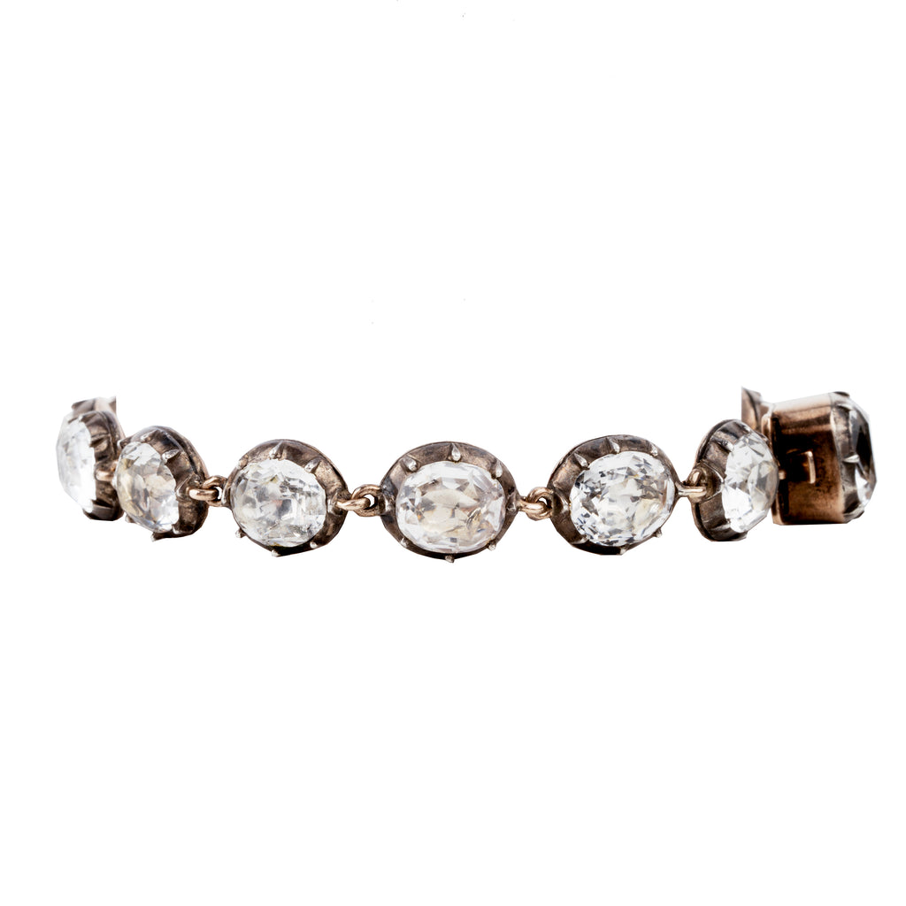 In the same form as the highly desired paste rivière necklaces, this bracelet was likely once part of a larger parure. The stones are not leaded glass paste but rock crystal quartz. Each is slightly different in size and proportion. Set in silver-topped gold collet settings. England, circa 1820. side view.