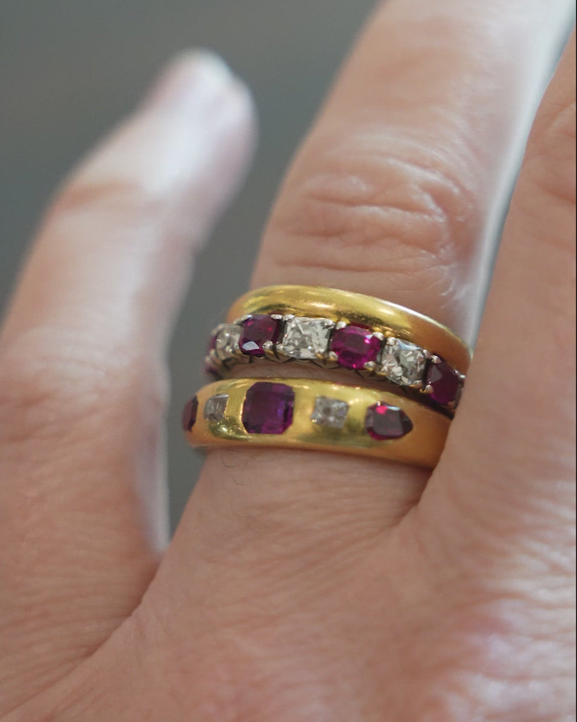 Victorian-era gypsy set ruby and diamond ring in 18k gold. A great mixture of high-crowned old mine cut diamonds with step-cut and shield-shaped rubies flush set. England, Circa 1880.