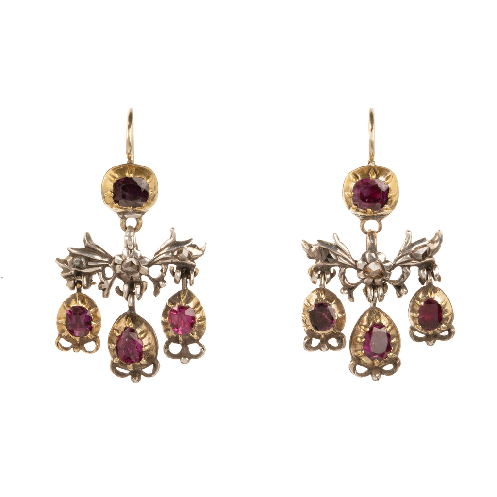 The girandole design consists of three pear-shaped drops suspended from a central bow motif. The design was popular towards the end of the 17th century through the 18th century. When the style's popularity diminished, elements were often disassembled and utilized in reduced form, making examples in original form quite rare. Rose-cut diamonds are set into the central element in silver, while the ruby stones are set in 18k gold. Continental Europe, circa 1760. Front view. 