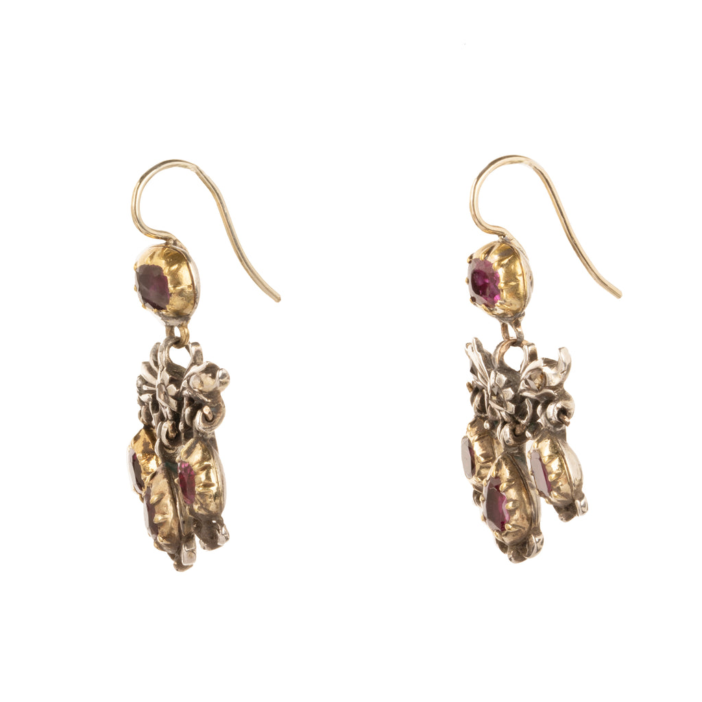The girandole design consists of three pear-shaped drops suspended from a central bow motif. The design was popular towards the end of the 17th century through the 18th century. When the style's popularity diminished, elements were often disassembled and utilized in reduced form, making examples in original form quite rare. Rose-cut diamonds are set into the central element in silver, while the ruby stones are set in 18k gold. Continental Europe, circa 1760. Side view. 