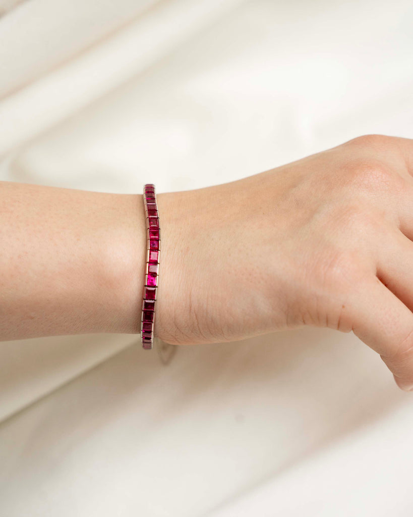 Art Deco ruby line bracelet. A fine early 20th-century platinum line bracelet. Natural deep red step-cut rubies are primarily Burmese in origin. Approximated at 11 carats in total stone weight. America, circa 1920. The bracelet on a model bracelet. 