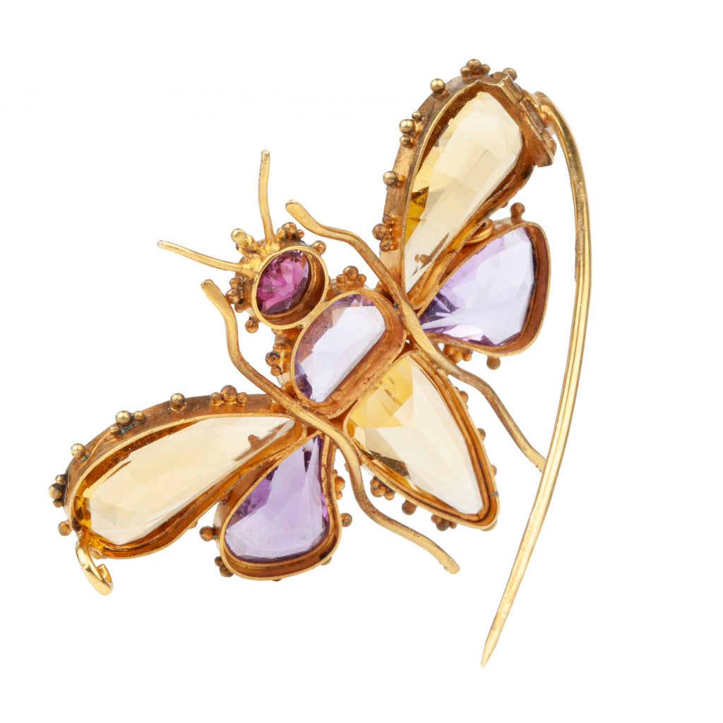 Finely made early Victorian citrine, amethyst and garnet butterfly brooch, set in gold. Beautiful combination of contrasting amethyst and citrine wings. In Etruscan revival motif. English in origin. Circa 1850. Back side view. 