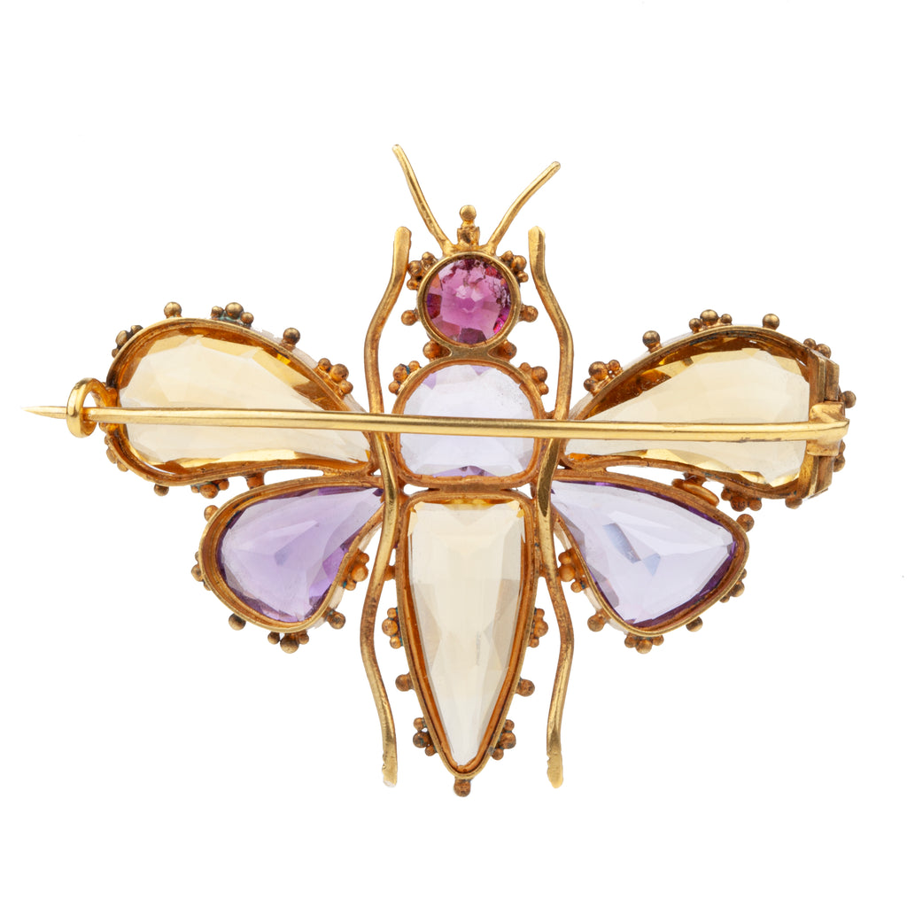 Finely made early Victorian citrine, amethyst and garnet butterfly brooch, set in gold. Beautiful combination of contrasting amethyst and citrine wings. In Etruscan revival motif. English in origin. Circa 1850. Close-up back side view. 