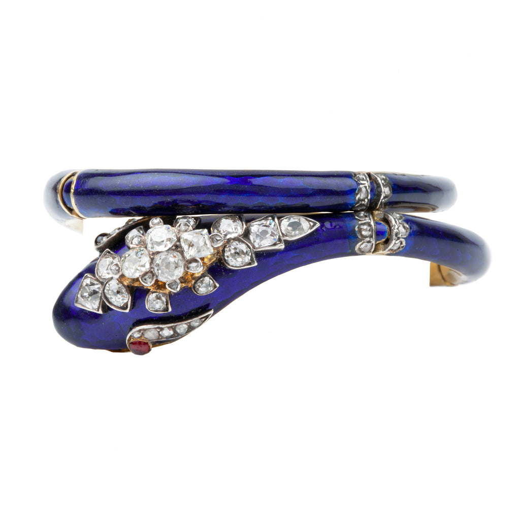 19th century snake bangle, set with both old mine cut and rose cut diamonds.ruby eyes. The body is crafted in 18k gold and hinged at 4 points allowing for a varied fit. English in origin. Circa 1860.