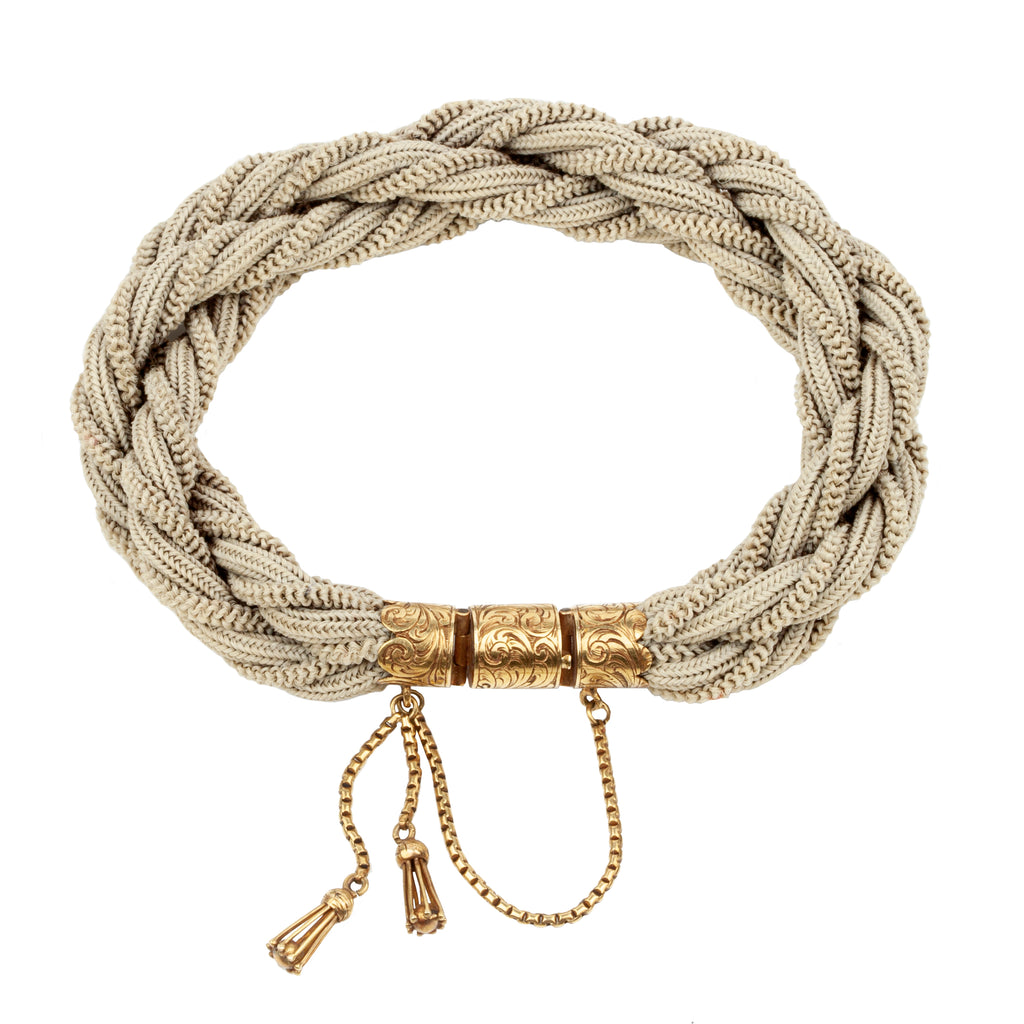 Victorian Era woven hair bracelet, with gold clasp and tassel details. Remarkably preserved twisted woven braids. English in origin. Circa 1860.